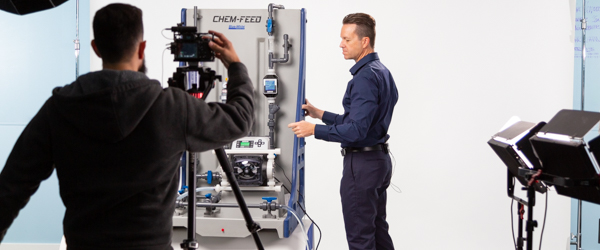 A professional on set demonstrating industrial equipment while being filmed, representing Coldea Productions' expertise as a video production agency for video content marketing.