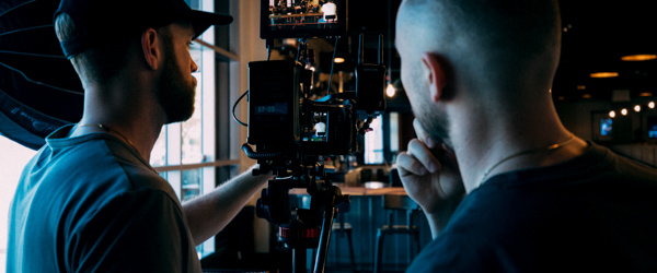 Videographers setting up a camera for an indoor shoot, ideal for video production services in Phoenix, AZ, by Coldea Productions.