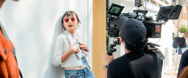 Videographer filming a model in an outdoor setting, ideal for video production services in Phoenix, AZ, by Coldea Productions.