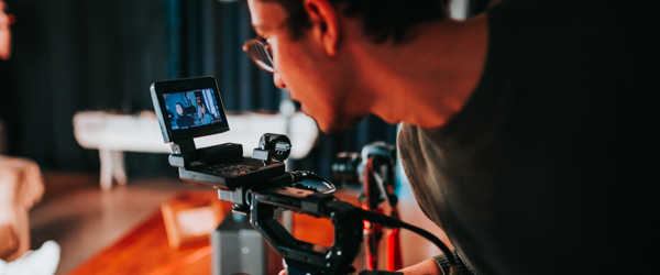 Coldea Productions videographer filming an interview, capturing the subject on a high-definition monitor.