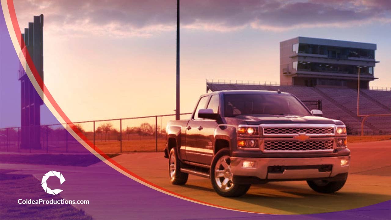 Chevrolet truck at sunset near a stadium, featured in a presentation video by Coldea Productions.